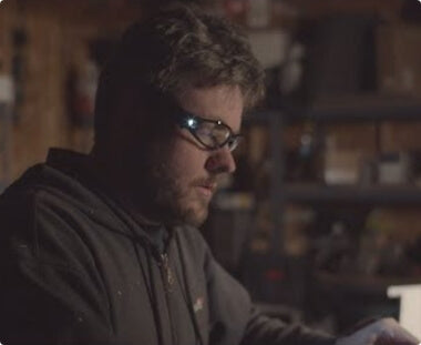 Man using lighted glasses while working