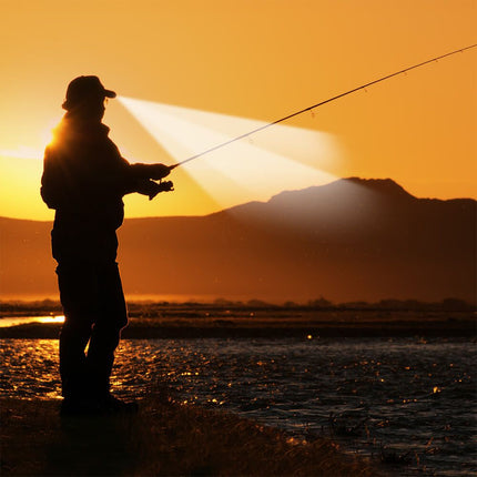 Person fishing using an LED lighted cap to see