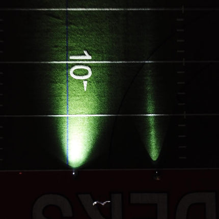 two figures from above on a football field holding rechargeable LED flashlights