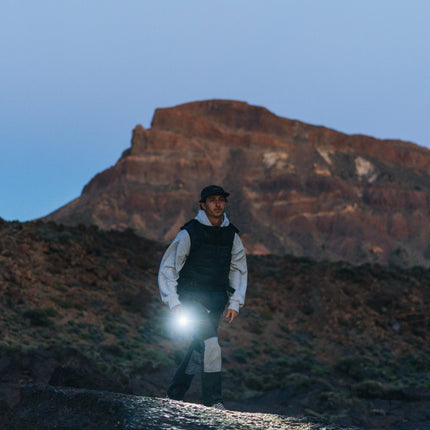 hiker in the mountains holding a rechargeable LED lantern flashlight