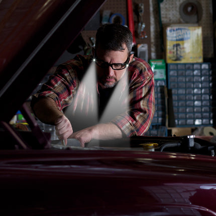 mechanic working on a car and wearing LIGHTSPECS vindicator LED lighted safety glasses