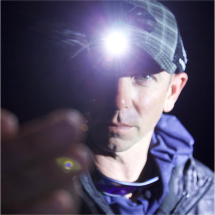 fisherman wearing a grey LED lighted headlamp hat