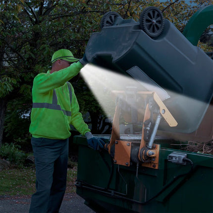 man wearing a yellow POWERCAP 25/10 LED lighted safety hat while loading garbage