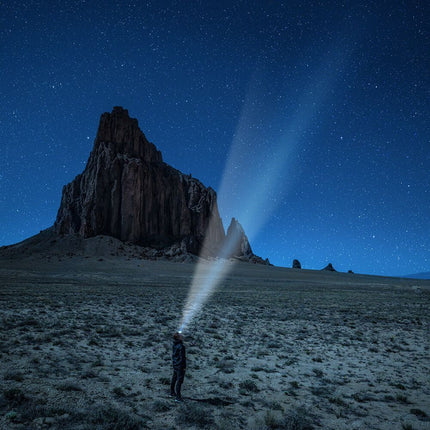 Man wearing a POWERCAP EXP 200 LED lighted headlamp hat in the desert and staring at the stars