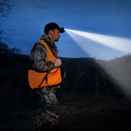 POWERCAP EXP 200 black LED lighted headlamp hat on a hunter in camo and an orange vest